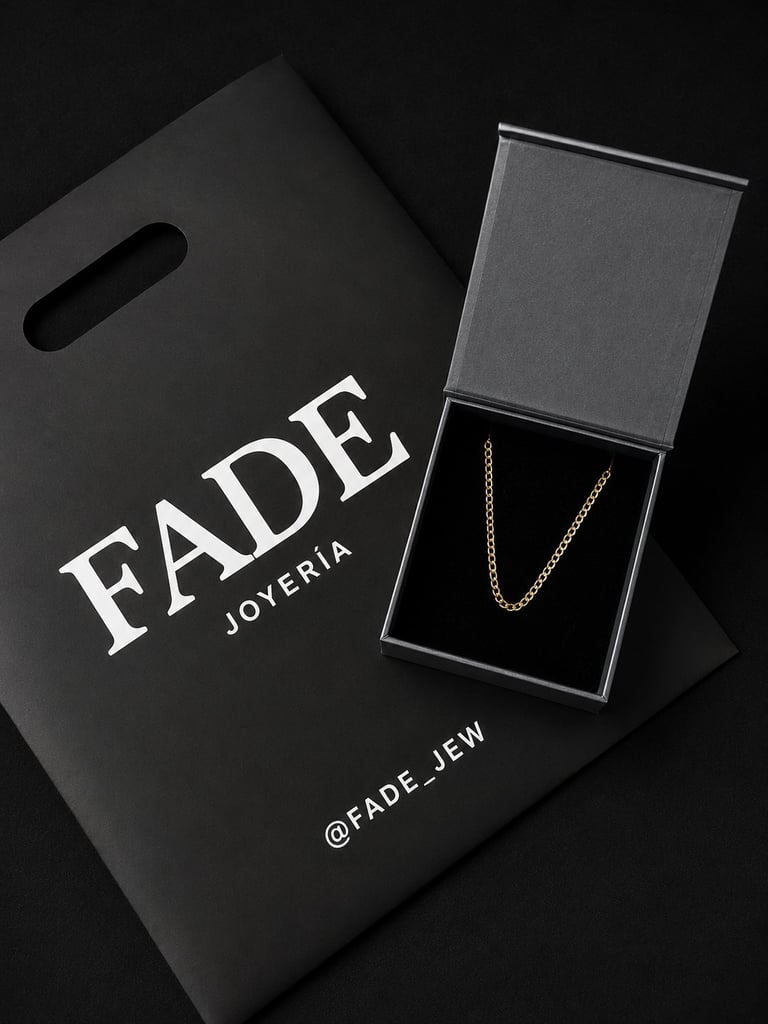 FADE Joyeria luxury gold chain necklace displayed in branded black box with shopping bag on dark background
